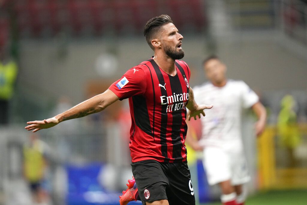 AC Milan's Olivier Giroud celebrates after scoring his side's third goal during a Serie A soccer match between AC Milan and Cagliari, at the San Siro stadium in Milan, Italy, Monday, Aug. 30, 2021. (AP Photo/Luca Bruno)