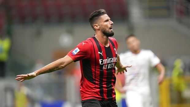 AC Milan's Olivier Giroud celebrates after scoring his side's third goal during a Serie A soccer match between AC Milan and Cagliari, at the San Siro stadium in Milan, Italy, Monday, Aug. 30, 2021. (AP Photo/Luca Bruno)