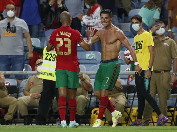 Portugal's Cristiano Ronaldo, right, celebrates after scoring his side's second goal during the World Cup 2022 group A qualifying soccer match between Portugal and the Republic of Ireland at the Algarve stadium outside Faro, Portugal, Wednesday, Sept. 1, 2021. (AP Photo/Armando Franca)