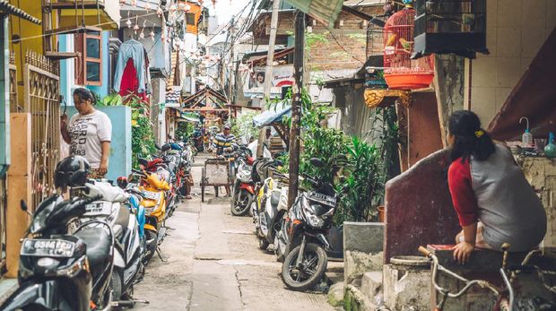 Jakarta, Indonesia - October 30, 2016: View of one of the alley in the outskirts of the giant city. People doing various activitie. These poor neighborhood constitute the majority of the capital city.