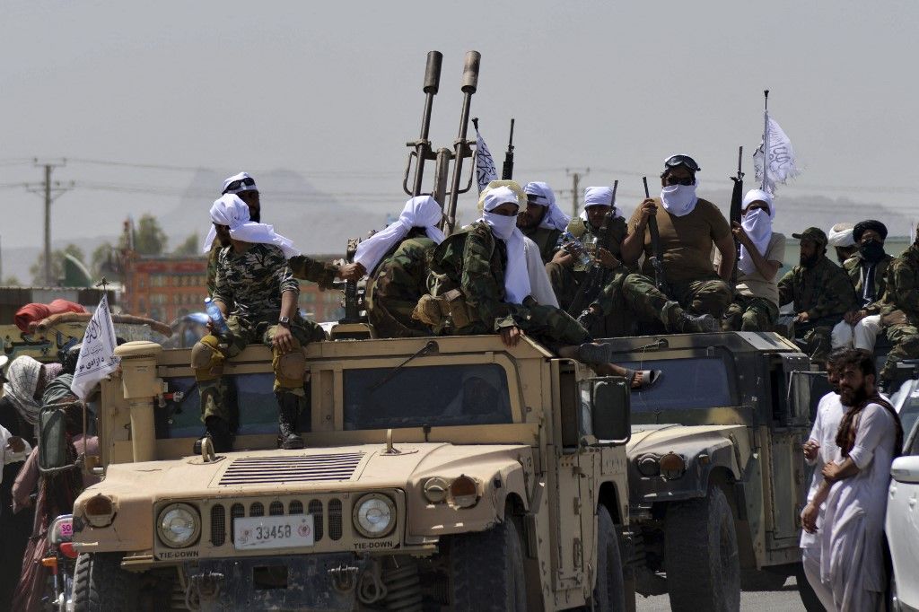 Taliban fighters atop Humvee vehicles parade along a road to celebrate after the US pulled all its troops out of Afghanistan, in Kandahar on September 1, 2021 following the Talibans military takeover of the country. (Photo by JAVED TANVEER / AFP)