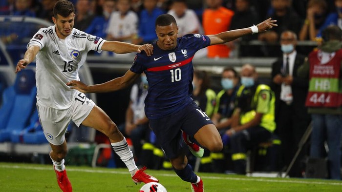 Frances Kylian Mbappe dribbles Bosnias Branimir Cipetic during the World Cup 2022 group D qualifying soccer match between France and Bosnia at La Meinau stadium in Strasbourg, eastern France, Wednesday, Sept.1 2021. (AP Photo/Jean-Francois Badias)