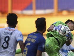 Kiper serius menangkap bola.