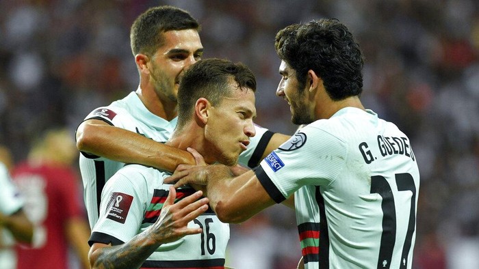 Otavio of Portugal, center, celebrates his goal with teammates Andre Silva, left, and Goncalo Guedes, right, during a friendly soccer match between Qatar and Portugal in Nagyerdei Stadium in Debrecen, Hungary, Saturday, Sept. 4, 2021. (Zsolt Czegledi/MTI via AP)