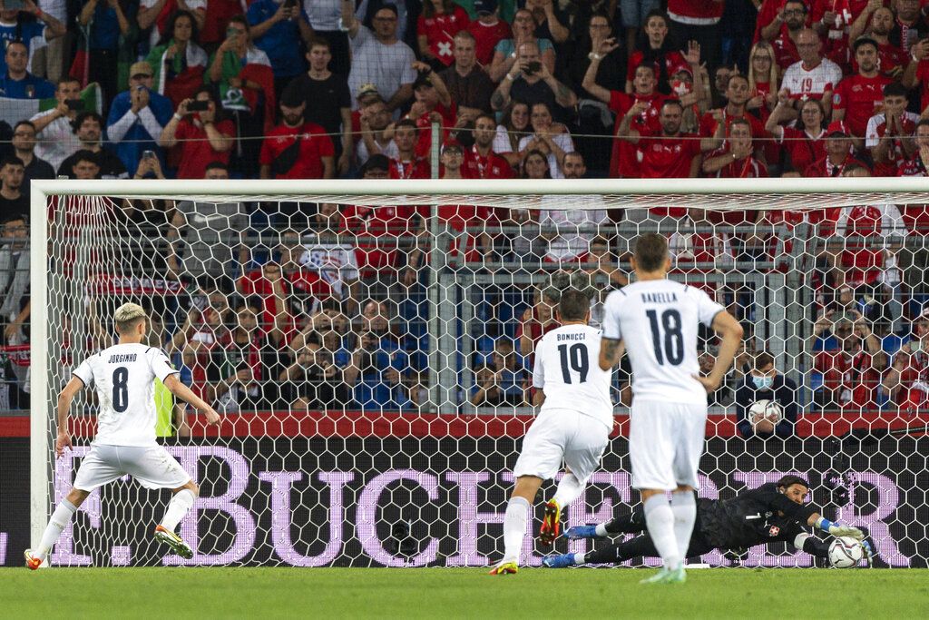 Switzerland goalkeeper Yann Sommer, right, catches the penalty kick of Italy's Jorginho, left, during the World Cup 2022 Group C qualifying soccer match between Switzerland and Italy at the St. Jakob-Park stadium in Basel, Switzerland, on Sunday, Sept. 5, 2021. (Jean-Christophe Bott/Keystone via AP)