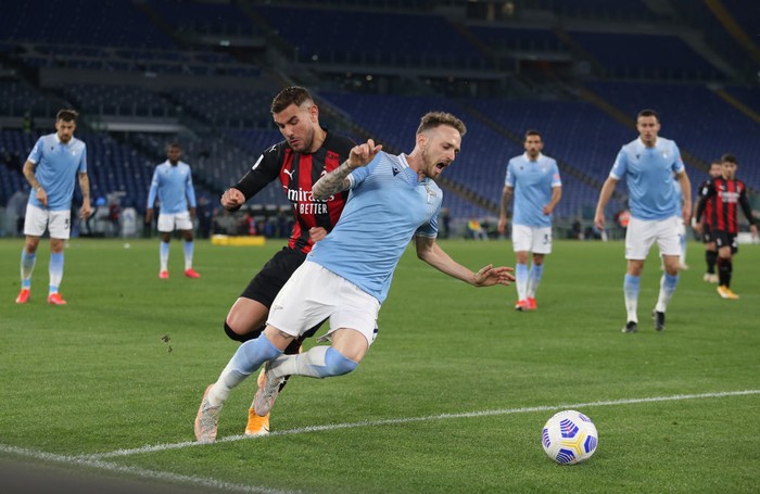 ROME, ITALY - APRIL 26: Theo Hernandez of A.C. Milan tackles Manuel Lazzari of SS Lazio  during the Serie A match between SS Lazio and AC Milan at Stadio Olimpico on April 26, 2021 in Rome, Italy. Sporting stadiums around Italy remain under strict restrictions due to the Coronavirus Pandemic as Government social distancing laws prohibit fans inside venues resulting in games being played behind closed doors. (Photo by Paolo Bruno/Getty Images)