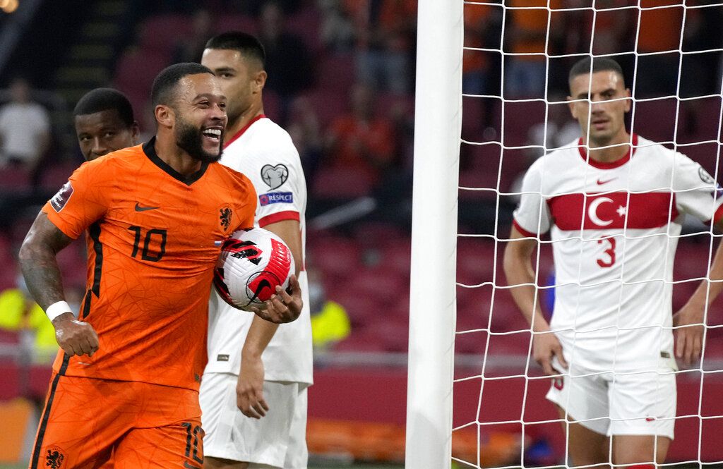 Memphis Depay of the Netherlands celebrates scoring his side's first goal during the World Cup 2022 group G qualifying soccer match between the Netherlands and Montenegro at the Philips stadium in Eindhoven, Netherlands, Saturday, Sept. 4, 2021. (AP Photo/Peter Dejong)