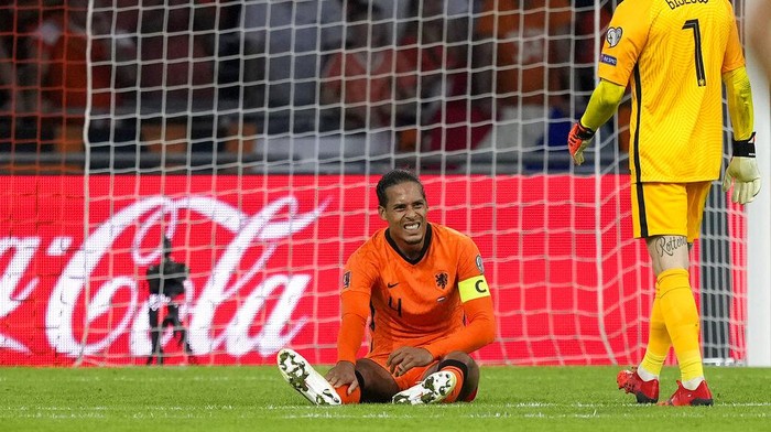 Virgil van Dijk of the Netherlands is injured during the World Cup 2022 group G qualifying soccer match between the Netherlands and Turkey at the Johan Cruyff Arena in Amsterdam, Netherlands, Tuesday, Sept. 7, 2021. (AP Photo/Peter Dejong)
