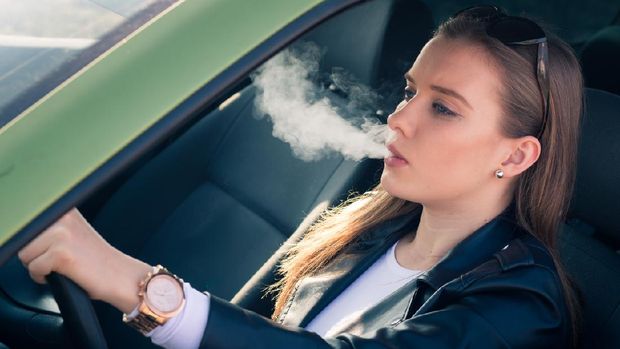 Woman smoking in a car
