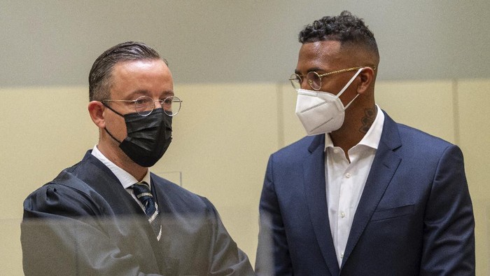 Professional footballer and former national player Jerome Boateng, right, stands with his lawyer Kai Walden, left, at the beginning of the trial against him at the District Court in Munich, Germany, Thursday, Sept. 9, 2021. Boateng is being tried on charges of assault. (Peter Kneffel /dpa via AP)
