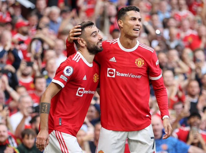 Manchester United MANCHESTER, ENGLAND - SEPTEMBER 11: Bruno Fernandes of Manchester United celebrates with Cristiano Ronaldo after scoring their side's third goal during the Premier League match between Manchester United and Newcastle United at Old Trafford on September 11, 2021 in Manchester, England. (Photo by Clive Brunskill/Getty Images)