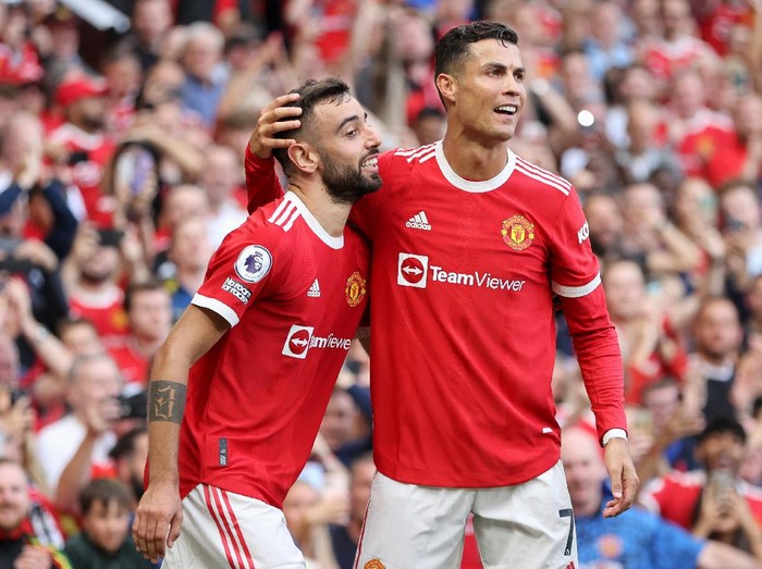 MANCHESTER, ENGLAND - SEPTEMBER 11: Bruno Fernandes of Manchester United celebrates with Cristiano Ronaldo after scoring their side's third goal during the Premier League match between Manchester United and Newcastle United at Old Trafford on September 11, 2021 in Manchester, England. (Photo by Clive Brunskill/Getty Images)