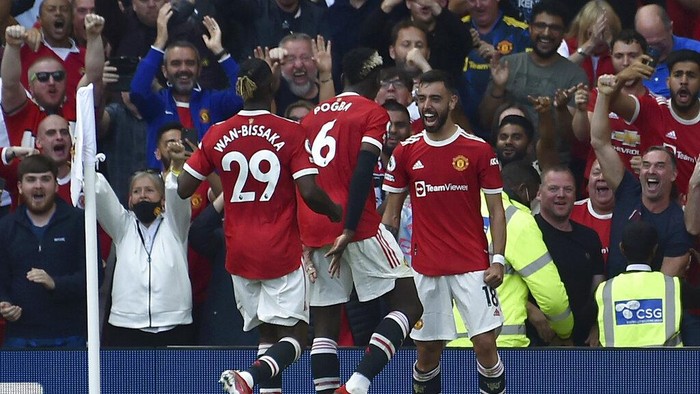 Manchester Uniteds Bruno Fernandes, right, celebrates after scoring his sides third goal during the English Premier League soccer match between Manchester United and Newcastle United at Old Trafford stadium in Manchester, England, Saturday, Sept. 11, 2021. (AP Photo/Rui Vieira)
