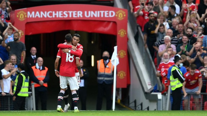 MANCHESTER, ENGLAND - SEPTEMBER 11: Cristiano Ronaldo of Manchester United celebrates with Bruno Fernandes after scoring their sides second goal during the Premier League match between Manchester United and Newcastle United at Old Trafford on September 11, 2021 in Manchester, England. (Photo by Laurence Griffiths/Getty Images)
