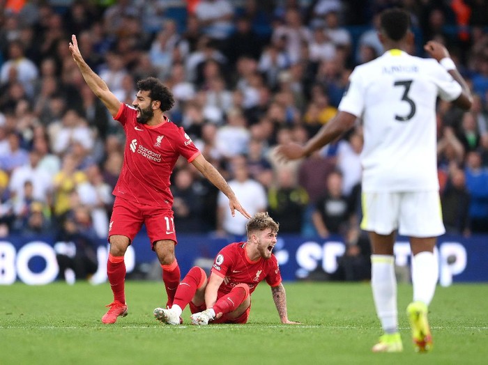 LEEDS, ENGLAND - SEPTEMBER 12: Harvey Elliott of Liverpool reacts as he looks to be injured as Mohamed Salah of Liverpool calls for medical attention during the Premier League match between Leeds United and Liverpool at Elland Road on September 12, 2021 in Leeds, England. (Photo by Laurence Griffiths/Getty Images)