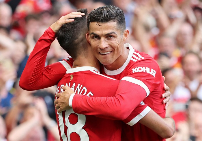MANCHESTER, ENGLAND - SEPTEMBER 11: Bruno Fernandes of Manchester United celebrates with Cristiano Ronaldo after scoring their sides third goal during the Premier League match between Manchester United and Newcastle United at Old Trafford on September 11, 2021 in Manchester, England. (Photo by Clive Brunskill/Getty Images)