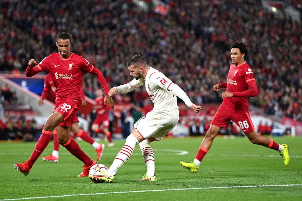 LIVERPOOL, ENGLAND - SEPTEMBER 15: Ante Rebic of AC Milan crosses the ball whilst under pressure from Joel Matip of Liverpool during the UEFA Champions League group B match between Liverpool FC and AC Milan at Anfield on September 15, 2021 in Liverpool, England. (Photo by Shaun Botterill/Getty Images)