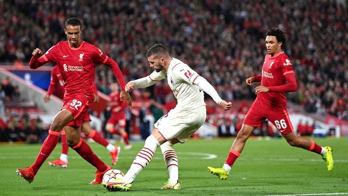 LIVERPOOL, ENGLAND - SEPTEMBER 15: Ante Rebic of AC Milan crosses the ball whilst under pressure from Joel Matip of Liverpool during the UEFA Champions League group B match between Liverpool FC and AC Milan at Anfield on September 15, 2021 in Liverpool, England. (Photo by Shaun Botterill/Getty Images)