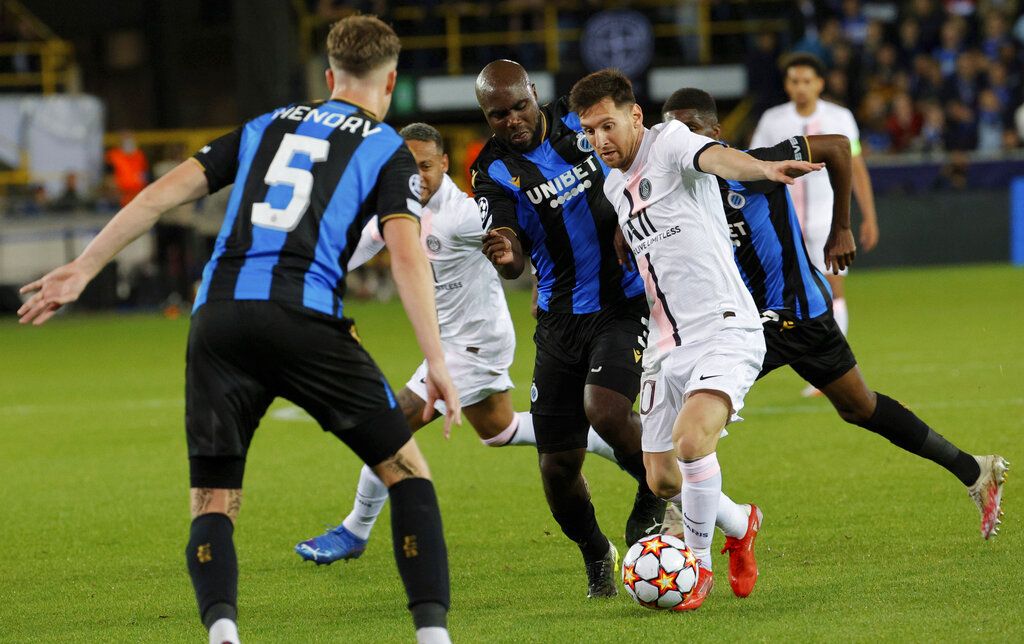 PSG's Lionel Messi, center right, fights for the ball with Brugge's Eder Balanta, center left, during the Champions League Group A soccer match between Club Brugge and PSG at the Jan Breydel stadium in Bruges, Belgium, Wednesday, Sept. 15, 2021. (AP Photo/Olivier Matthys)