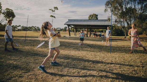 Group of children playing badminton in the park in Melbourne, Australia.