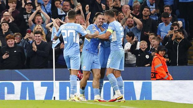 Manchester City's Jack Grealish, center, celebrates with teammates after scoring during the Champions League Group A soccer match between Manchester City and RB Leipzig at the Etihad Stadium, Manchester, England, Wednesday Sept. 15, 2021. (Zac Goodwin/PA via AP)