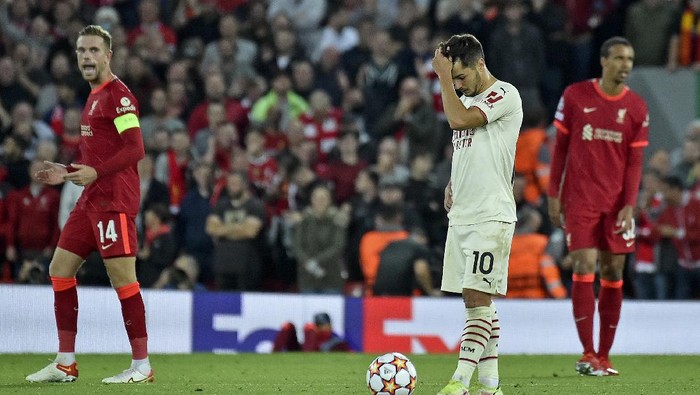 AC Milans Brahim Diaz reacts after Liverpools Jordan Henderson, left, celebrates scored his sides third goal during the Champions League Group B soccer match between Liverpool and AC Milan at Anfield, in Liverpool, England, Wednesday Sept. 15, 2021. (AP Photo/Rui Vieira)
