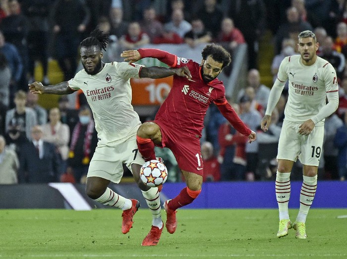 AC Milans Franck Kessie, left, challenges Liverpools Mohamed Salah during the Champions League Group B soccer match between Liverpool and AC Milan at Anfield, in Liverpool, England, Wednesday Sept. 15, 2021. (AP Photo/Rui Vieira)