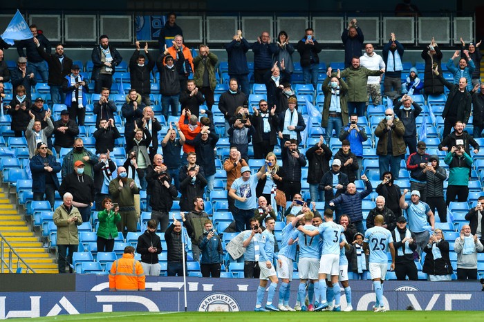 MANCHESTER, ENGLAND - MAY 23: Gabriel Jesus of Manchester City celebrates with teammates in front of their fans after scoring his teams second goal during the Premier League match between Manchester City and Everton at Etihad Stadium on May 23, 2021 in Manchester, England. A limited number of fans will be allowed into Premier League stadiums as Coronavirus restrictions begin to ease in the UK. (Photo by Peter Powell - Pool/Getty Images)