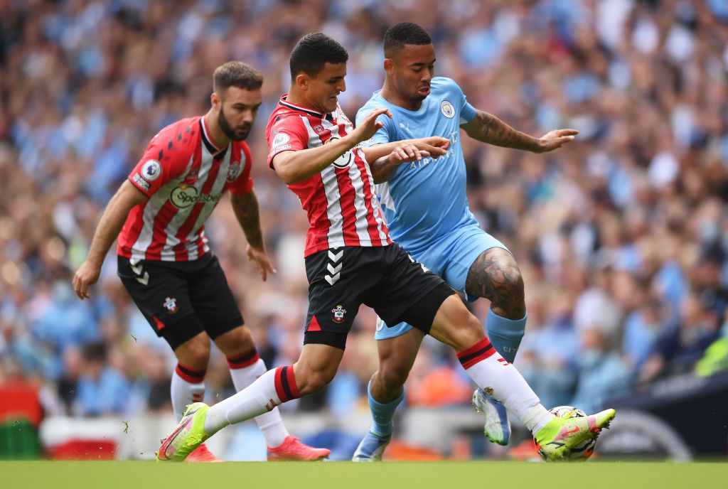 MANCHESTER, ENGLAND - SEPTEMBER 18: Gabriel Jesus of Manchester City is tackled by Mohamed Elyounoussi of Southampton during the Premier League match between Manchester City and Southampton at Etihad Stadium on September 18, 2021 in Manchester, England. (Photo by Laurence Griffiths/Getty Images)