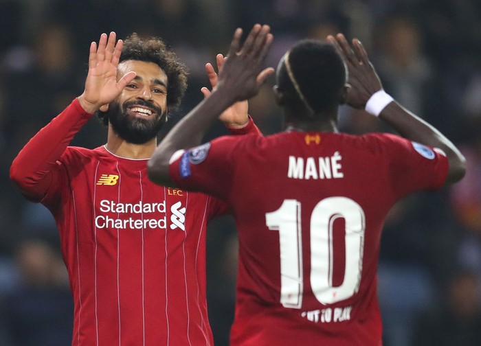 GENK, BELGIUM - OCTOBER 23: Mohamed Salah of Liverpool celebrates with teammate Sadio Mane after scoring his teams fourth goal during the UEFA Champions League group E match between KRC Genk and Liverpool FC at Luminus Arena on October 23, 2019 in Genk, Belgium. (Photo by Catherine Ivill/Getty Images)