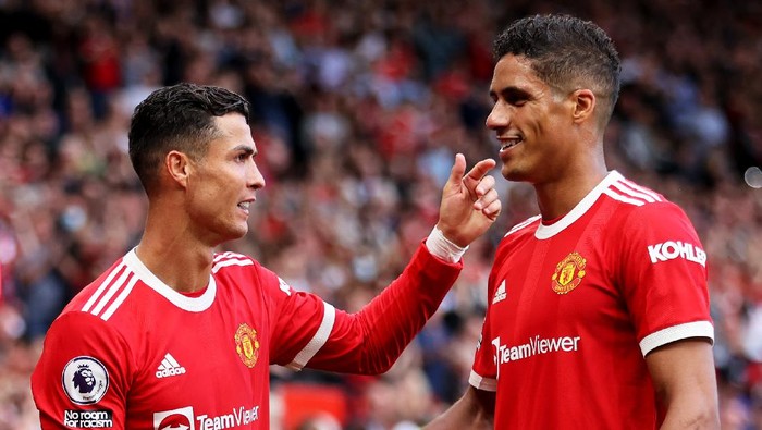 MANCHESTER, ENGLAND - SEPTEMBER 11: Cristiano Ronaldo of Manchester United with team mate Raphael Varane during the Premier League match between Manchester United and Newcastle United at Old Trafford on September 11, 2021 in Manchester, England. (Photo by Clive Brunskill/Getty Images)