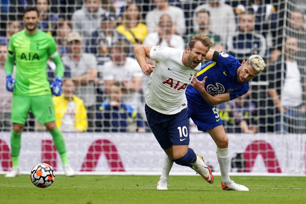 Tottenham's Harry Kane, center, reacts as Chelsea's Antonio Rudiger, foreground with number 2, celebrates after scoring his side's third goal during the English Premier League soccer match between Tottenham Hotspur and Chelsea at the Tottenham Hotspur Stadium in London, England, Sunday, Sep. 19, 2021. (AP Photo/Matt Dunham)