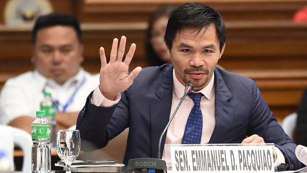 (FILES) This file photo taken on March 6, 2017 shows Philippine boxing icon and senator Manny Pacquiao during a senate hearing in Manila. - Philippine boxer-turned-politician Manny Pacquiao declared on September 19, 2021 he will run for president in 2022, ending months of speculation about whether the legendary fighter would seek the country's top job. (Photo by Ted ALJIBE / AFP)