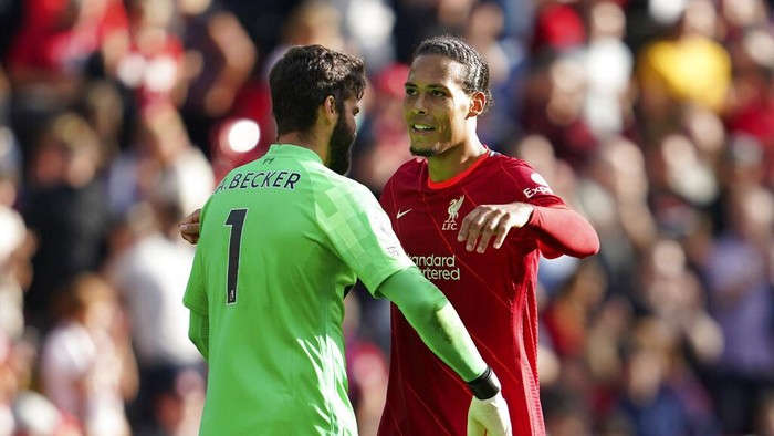 Liverpools Virgil van Dijk and Liverpools goalkeeper Alisson celebrate at the end of the English Premier League soccer match between Liverpool and Crystal Palace at Anfield Stadium, Liverpool, England, Saturday Sep. 18, 2021. Liverpool won 3-0. (AP Photo/Jon Super)