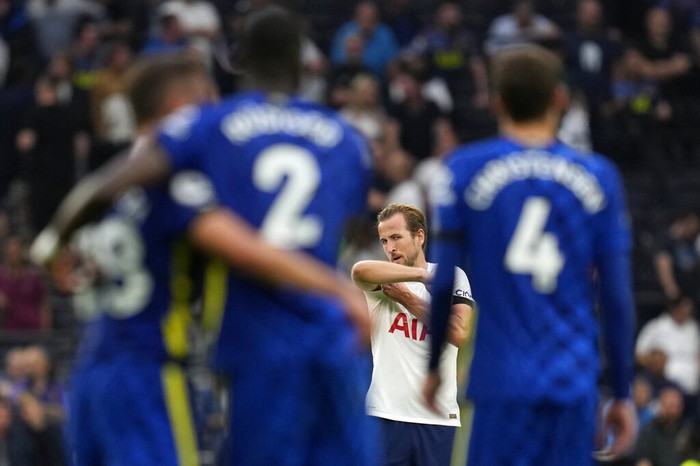 Tottenhams Harry Kane, center, reacts as Chelseas Antonio Rudiger, foreground with number 2, celebrates after scoring his sides third goal during the English Premier League soccer match between Tottenham Hotspur and Chelsea at the Tottenham Hotspur Stadium in London, England, Sunday, Sep. 19, 2021. (AP Photo/Matt Dunham)
