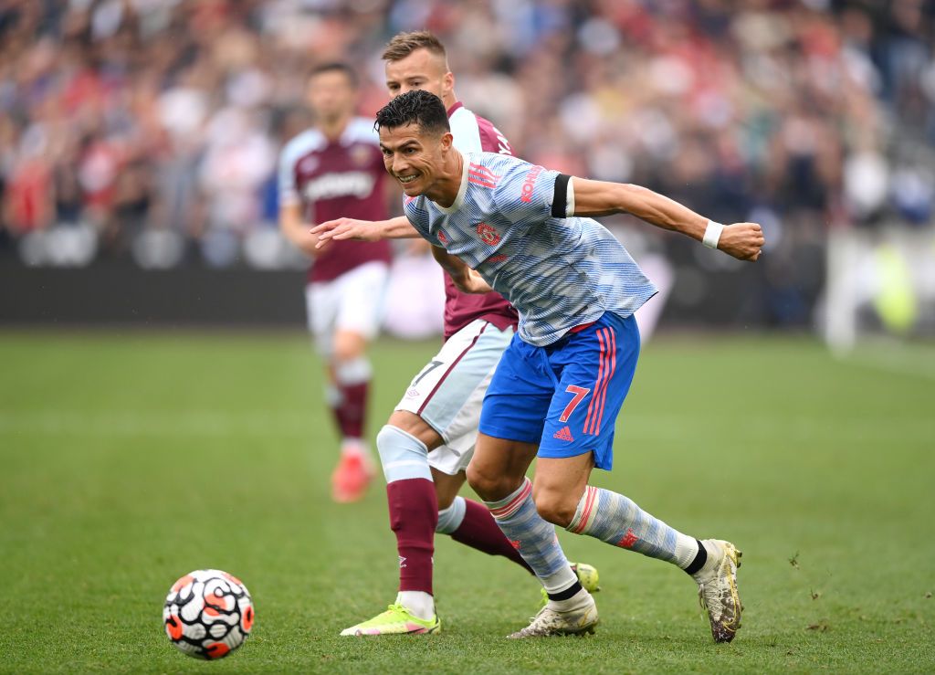 LONDON, ENGLAND - SEPTEMBER 19: Cristiano Ronaldo of Manchester United is challenged by Andriy Yarmolenko of West Ham United during the Premier League match between West Ham United and Manchester United at London Stadium on September 19, 2021 in London, England. (Photo by Justin Setterfield/Getty Images)