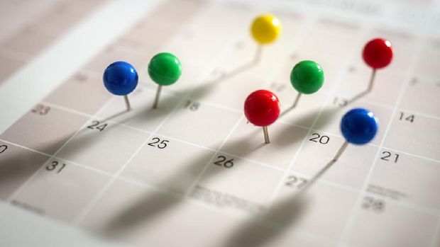 Thumbtack pins in calendar concept for busy, appointment and meeting reminder