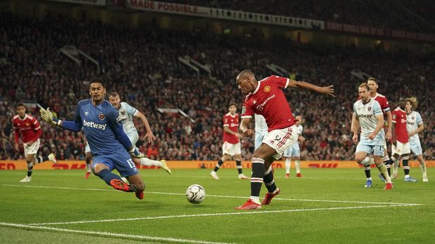 Manchester United's Anthony Martial, center, misses a chance during the English League Cup soccer match between Manchester United and West Ham at Old Trafford in Manchester, England, Wednesday, Sept. 22, 2021. (AP Photo/Dave Thompson)