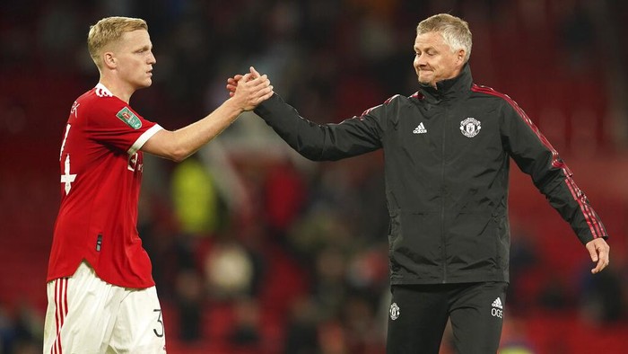 Manchester Uniteds manager Ole Gunnar Solskjaer greets Donny van der Beek at the end of the English League Cup soccer match between Manchester United and West Ham at Old Trafford in Manchester, England, Wednesday, Sept. 22, 2021. West Ham won the match 1-0. (AP Photo/Dave Thompson)