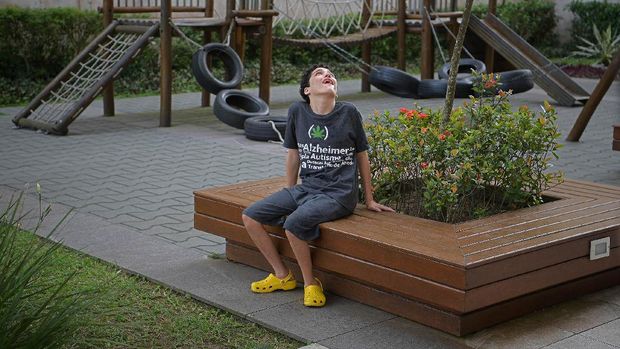 Gabriel Guerra, who suffers from severe autism and cerebral palsy, poses for a picture in Rio de Janeiro, Brazil, on September 20, 2021. - Ricardo gives his son medicinal cannabis in the form of droplets to help his severe autism and cerebral palsy. His son was told at an early age that he would never be able to be mobile but the medicine has stopped his seizures and allowed him to walk. (Photo by Carl de Souza / AFP)