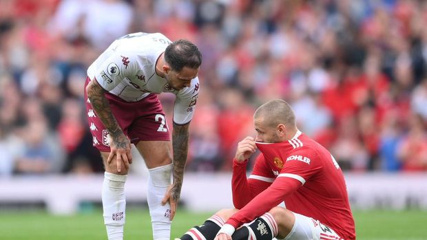 MANCHESTER, ENGLAND - SEPTEMBER 25: An injured Luke Shaw of Manchester United is checked on by Matty Cash of Aston Villa during the Premier League match between Manchester United and Aston Villa at Old Trafford on September 25, 2021 in Manchester, England. (Photo by Laurence Griffiths/Getty Images)