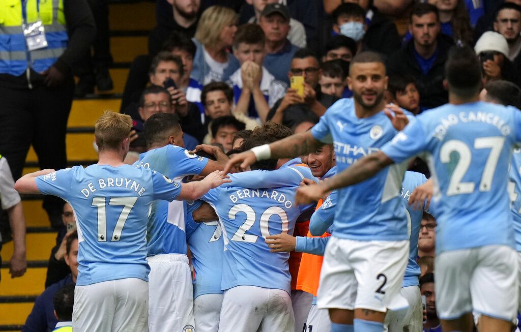 Manchester City's Gabriel Jesus celebrates with teammates after scoring his side's opening goal during the English Premier League soccer match between Chelsea and Manchester City at Stamford Bridge Stadium in London, Saturday, Sept. 25, 2021. (AP Photo/Alastair Grant)