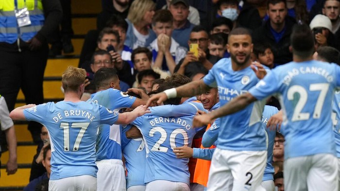 Manchester Citys Gabriel Jesus celebrates with teammates after scoring his sides opening goal during the English Premier League soccer match between Chelsea and Manchester City at Stamford Bridge Stadium in London, Saturday, Sept. 25, 2021. (AP Photo/Alastair Grant)
