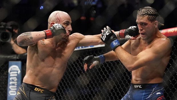 Alexander Volkanovski, left, throws a punch against Brian Ortega during a featherweight mixed martial arts title bout at UFC 266, Saturday, Sept. 25, 2021, in Las Vegas. (AP Photo/John Locher)