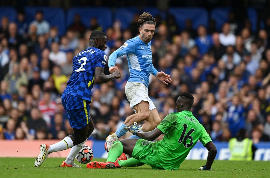 LONDON, ENGLAND - SEPTEMBER 25: Jack Grealish of Manchester City is challenged by Antonio Ruediger and Edouard Mendy of Chelsea during the Premier League match between Chelsea and Manchester City at Stamford Bridge on September 25, 2021 in London, England. (Photo by Shaun Botterill/Getty Images)
