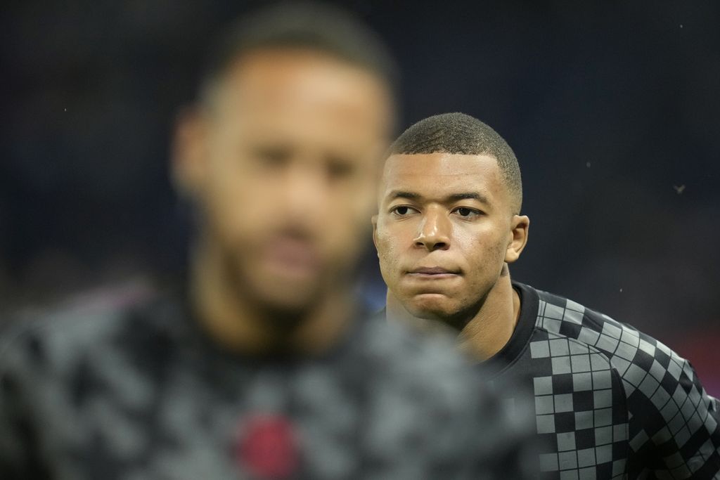 PSG's Kylian Mbappe and Neymar, left, exercise during warmup before the French League One soccer match between Paris Saint-Germain and Montpellier at the Parc des Princes stadium in Paris, Saturday, Sept. 25, 2021. (AP Photo/Christophe Ena)