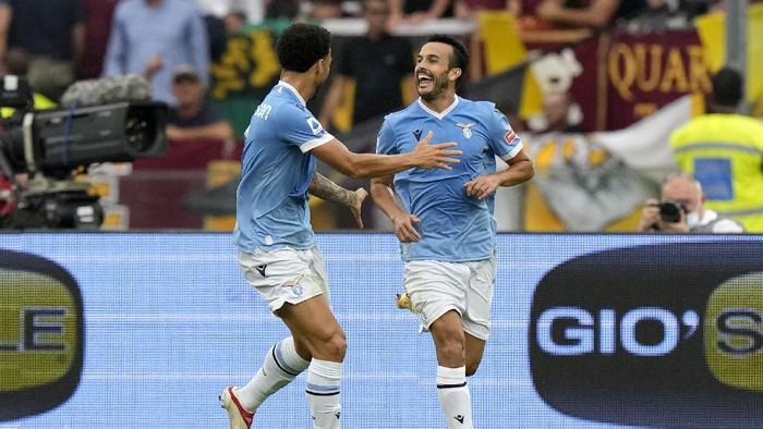 Lazios Pedro, right, celebrates after scoring his sides second goal during a Serie A soccer match between Lazio and Roma, at Romes Olympic Stadium, Sunday, Sept. 26, 2021. (AP Photo/Andrew Medichini)