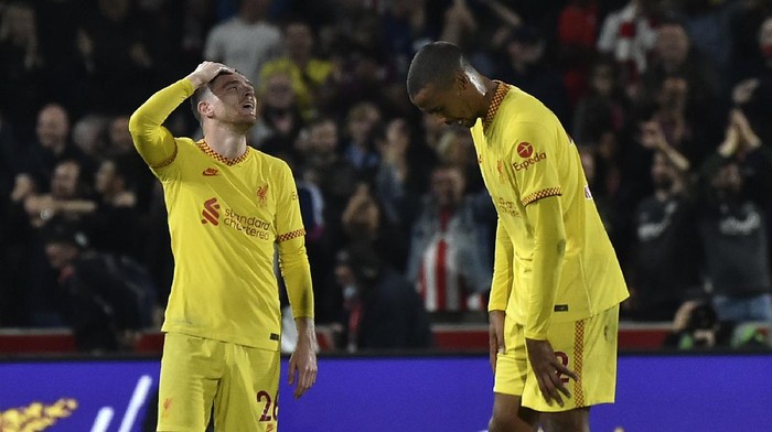 Liverpools Andrew Robertson, left, and Liverpools Joel Matip react after the English Premier League soccer match between Brentford and Liverpool at the Brentford Community Stadium in London, Saturday, Sept. 25, 2021. (AP Photo/Rui Vieira)