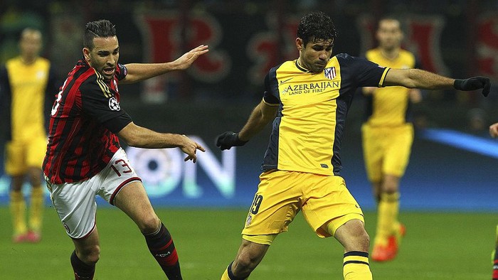 Milan vs Atletico 2014 MILAN, ITALY - FEBRUARY 19: Diego Costa (R) of Club Atletico de Madrid is challenged by Adil Rami (L) of AC Milan during the UEFA Champions League Round of 16 match between AC Milan and Club Atletico de Madrid at Stadio Giuseppe Meazza on February 19, 2014 in Milan, Italy. (Photo by Marco Luzzani/Getty Images)