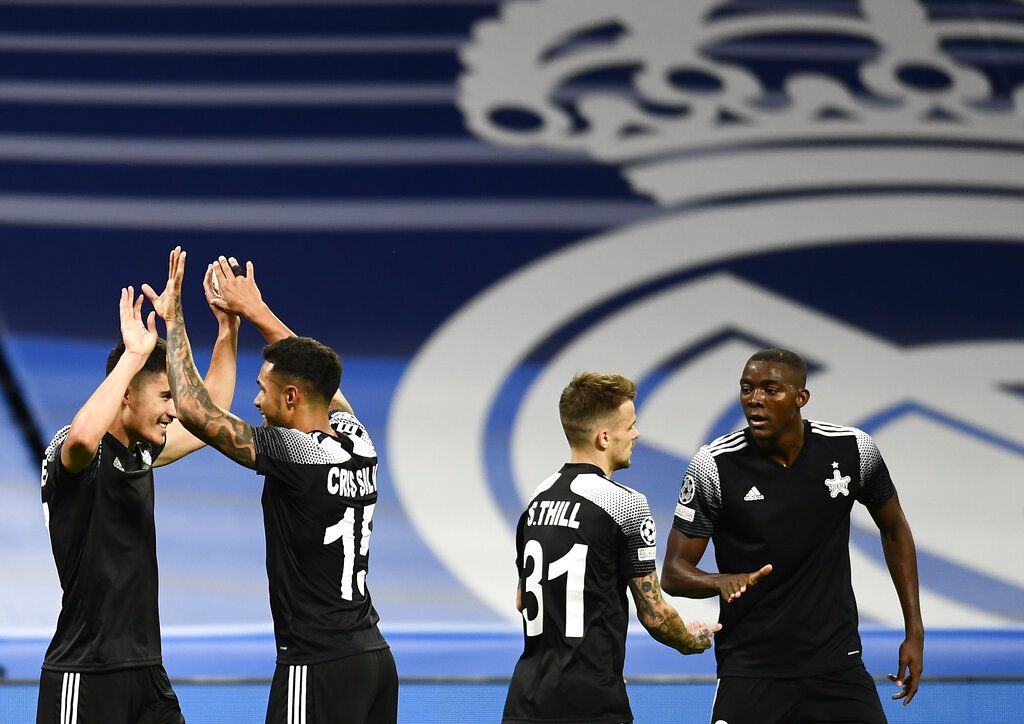 Sheriff's Jasurbek Yakhshiboev, left, celebrates with teammates after scoring his side's opening goal during the Champions League group D soccer match between Real Madrid and Sheriff, Tiraspol at the Bernabeu stadium in Madrid, Spain, Tuesday, Sept. 28, 2021. (AP Photo/Jose Breton)